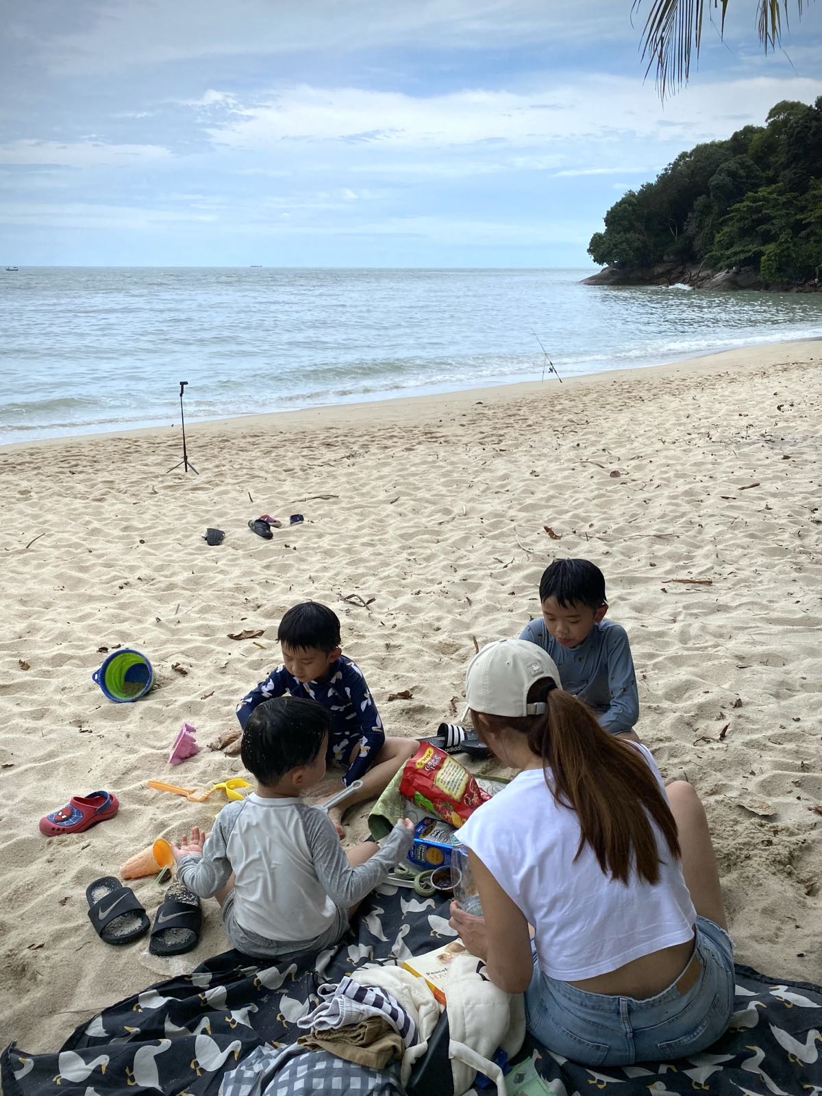 Nizz on the beach with her three boys, the family she bakes for